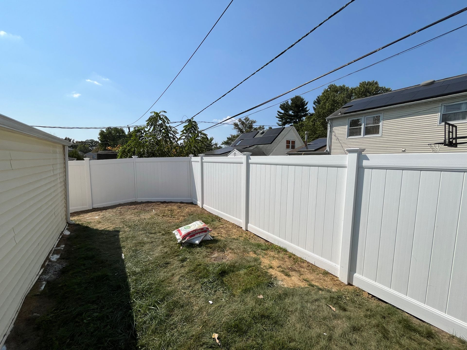 Wide backyard white vinyl fence installation in Burlington County NJ