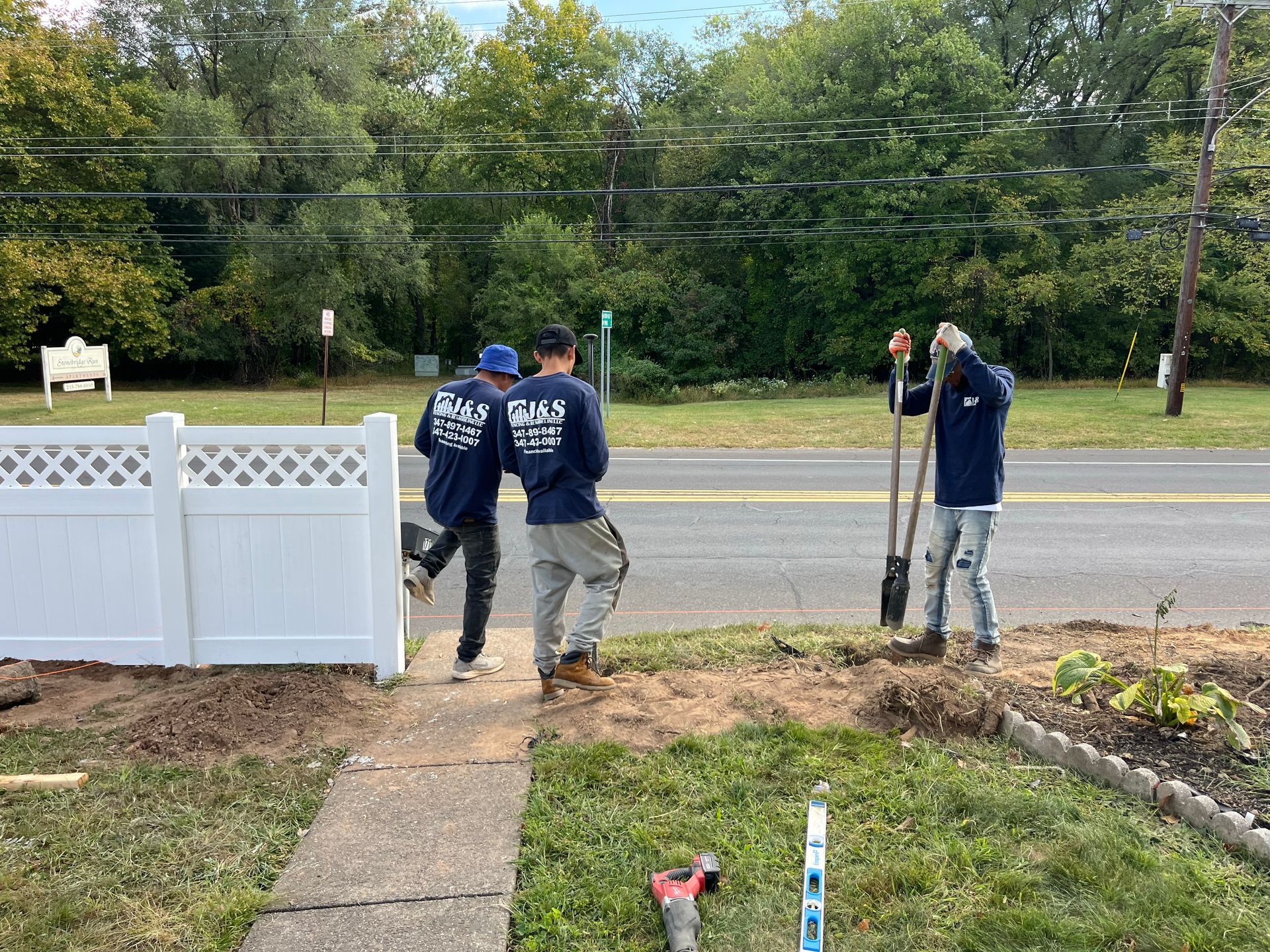 Lattice top vinyl fence installation in front yard in Burlington County NJ