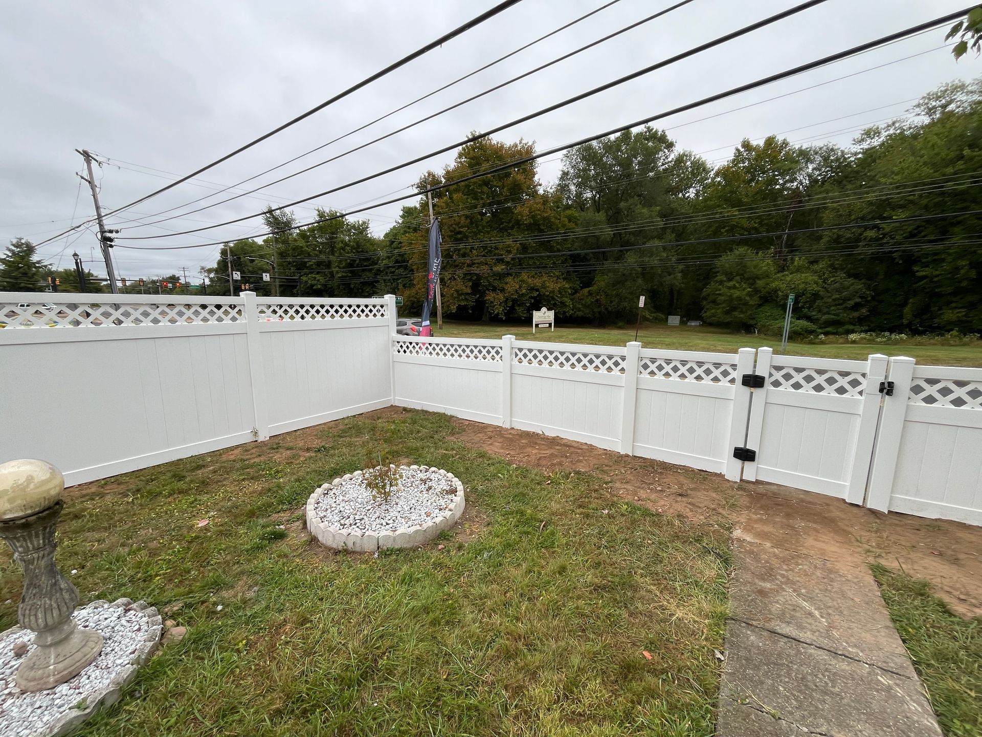 Completed lattice top vinyl backyard fence project in Burlington County NJ