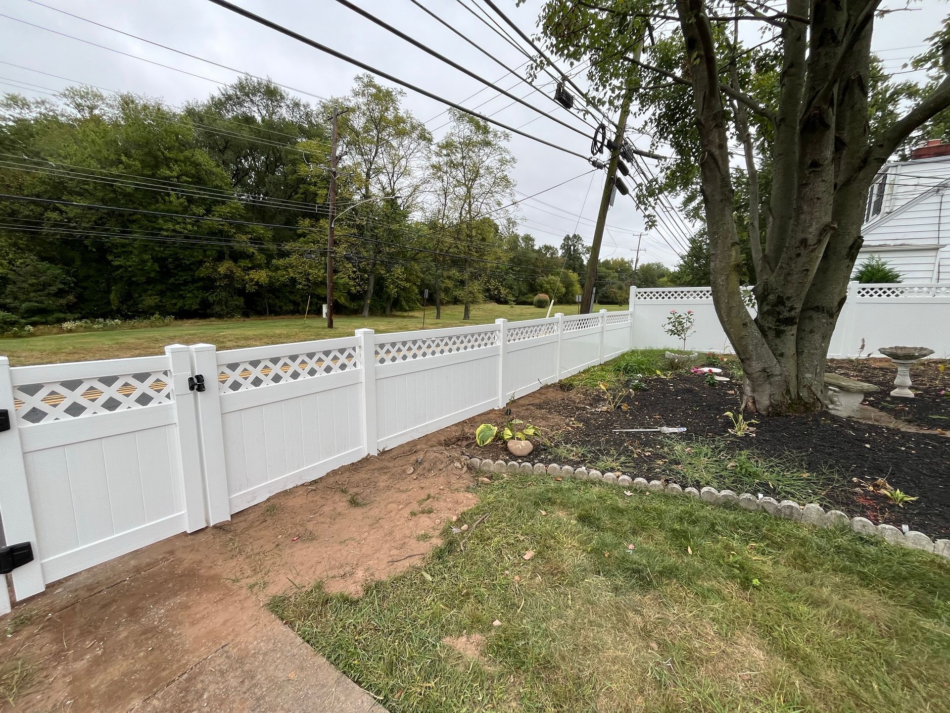 Long white lattice top vinyl fence line in Burlington County NJ