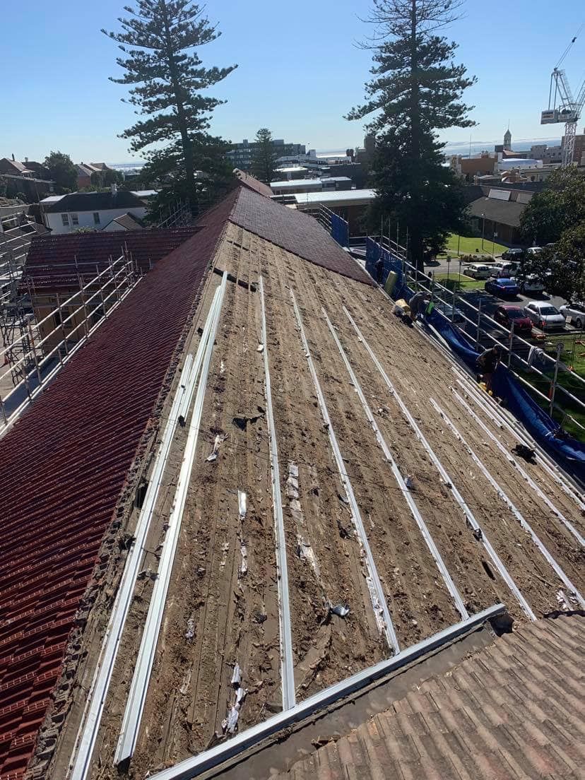 Rooftop With Red Tiles Undergoing Repair — Darren Smith Roofing In Glendale, NSW