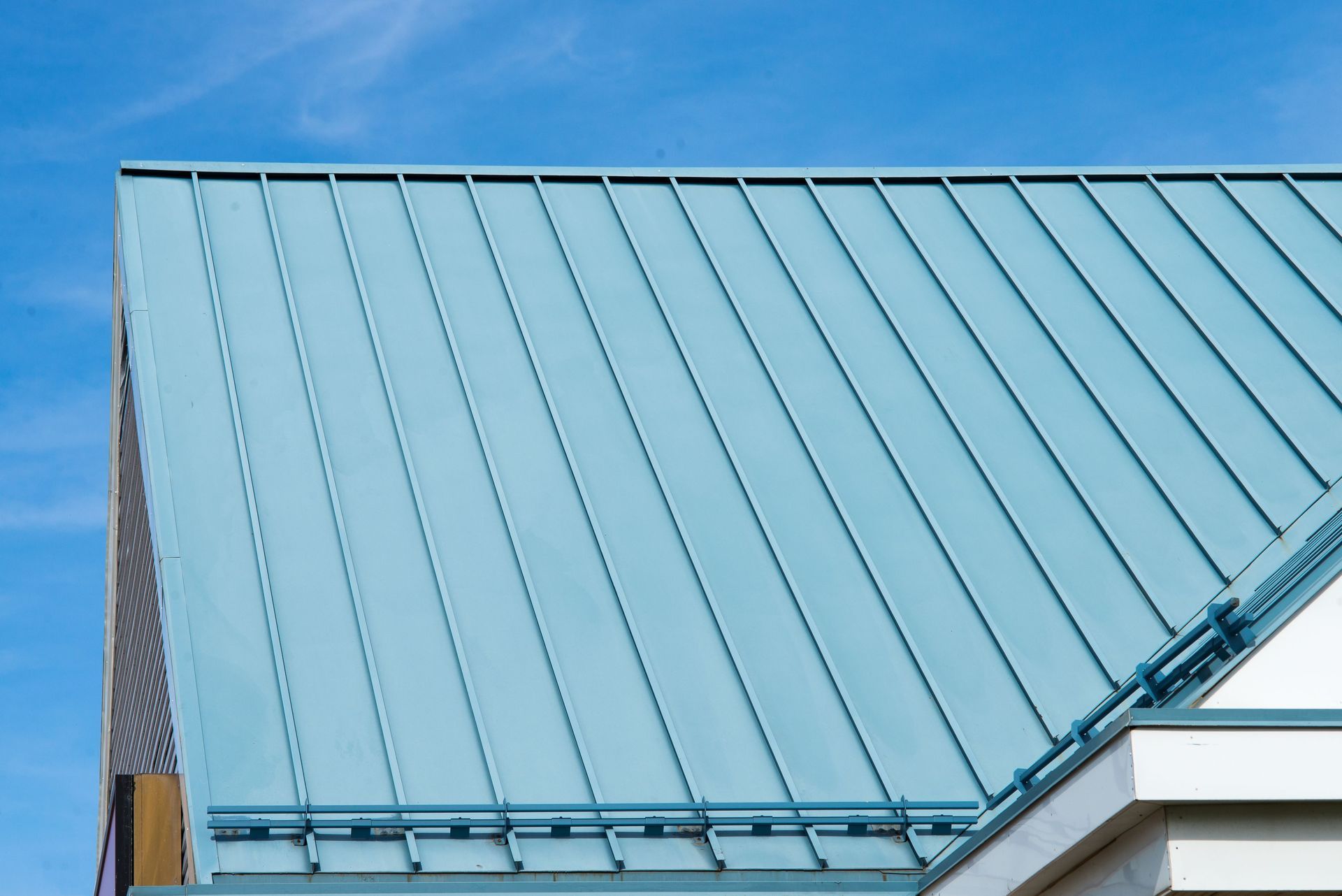 Blue Metal Roof Against a Clear Blue Sky — Darren Smith Roofing In Glendale, NSW