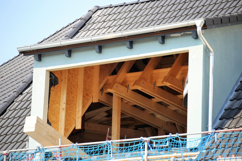 Construction Site: Open Attic Window Frame With Exposed Wooden Beams — Darren Smith Roofing In Glendale, NSW