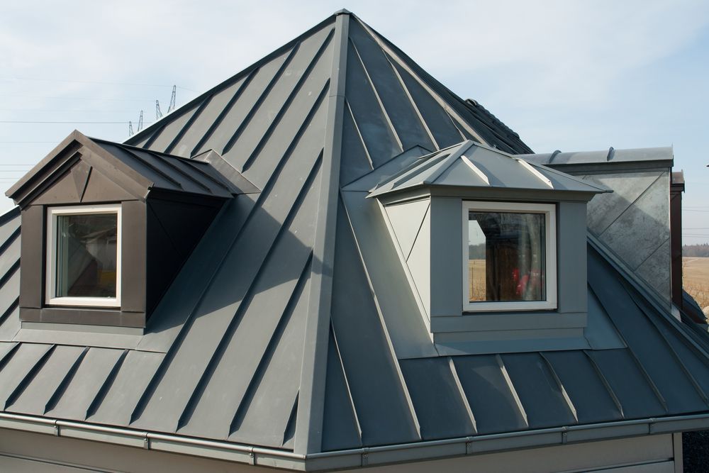 Gray Metal Roof With Two Dormer Windows Against a Clear Sky — Darren Smith Roofing In Glendale, NSW