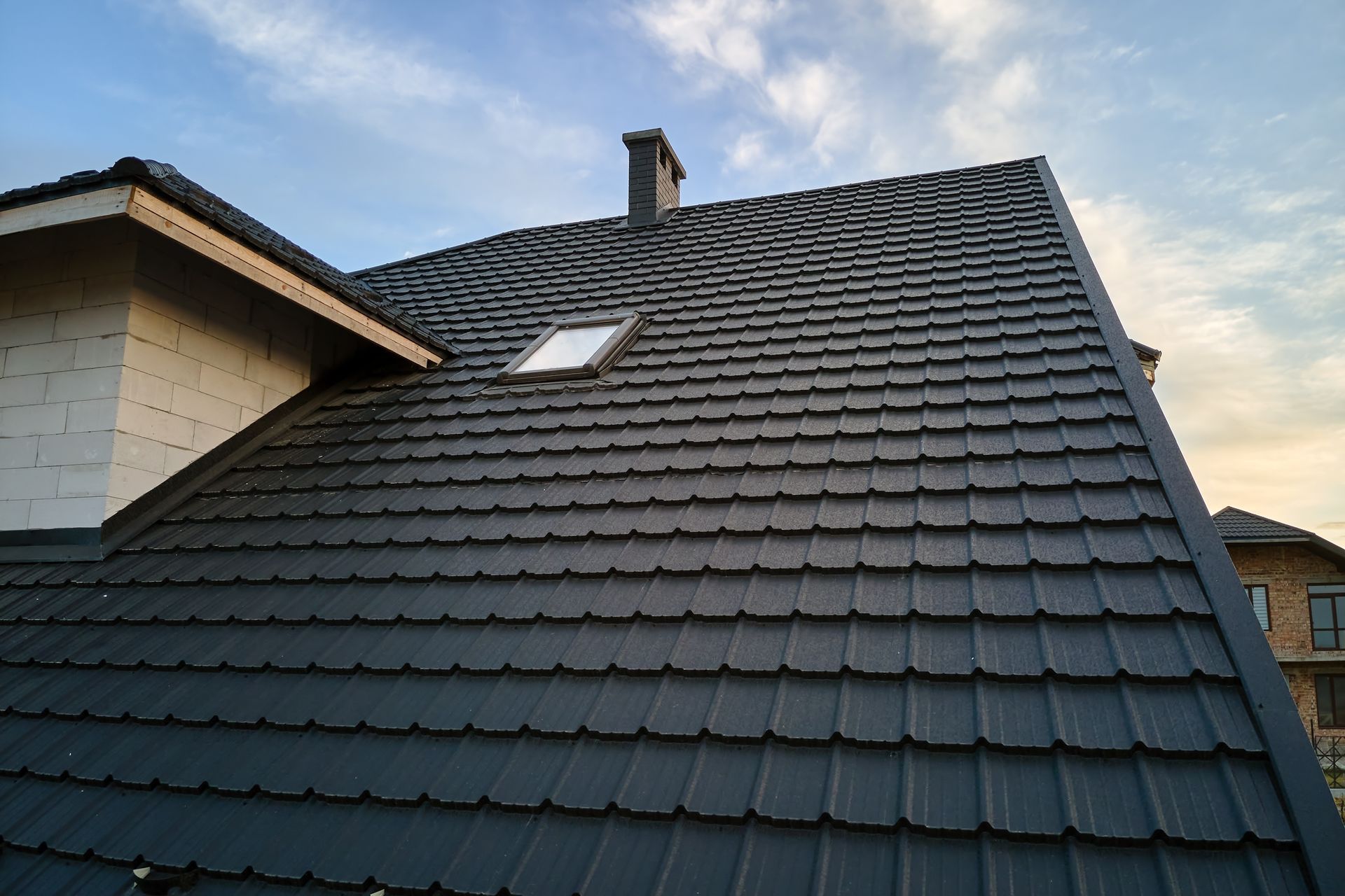 Dark Gray Metal Tile Roof on a House — Darren Smith Roofing in Glendale, NSW