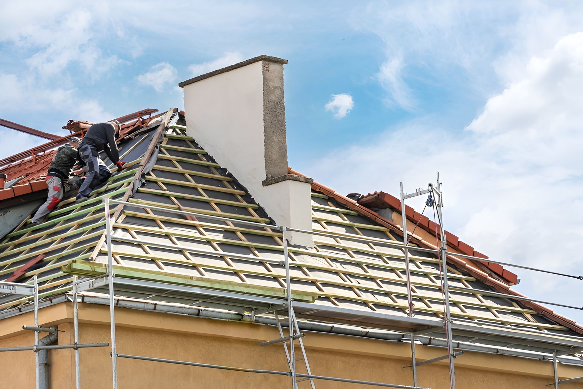 Roofers Installing Tiles on a House Roof, With Scaffolding — Darren Smith Roofing In Glendale, NSW