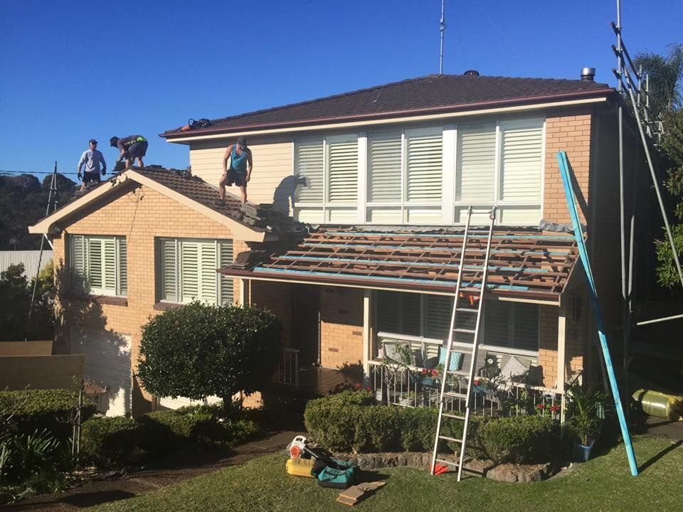 Roofers Working on a Two-story Brick House — Darren Smith Roofing In Glendale, NSW