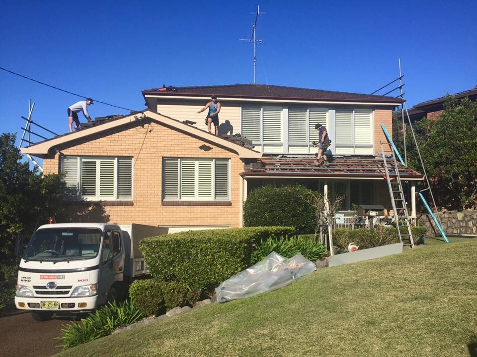 Roofers Working on a Two-story House — Darren Smith Roofing In Glendale, NSW
