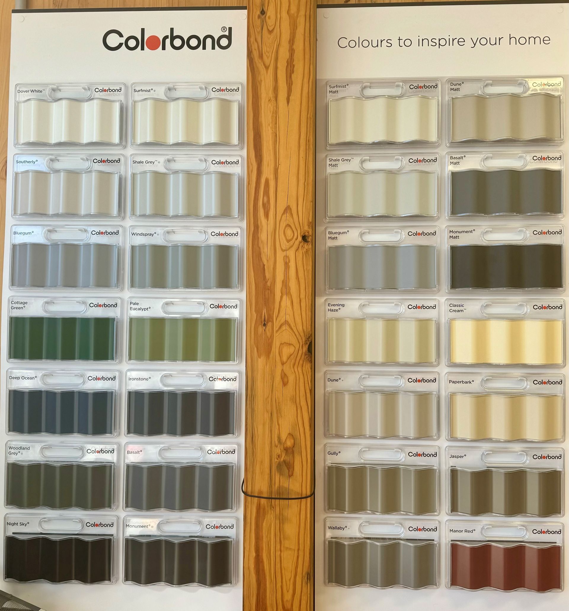 A display of colorbond paint samples on a wooden wall