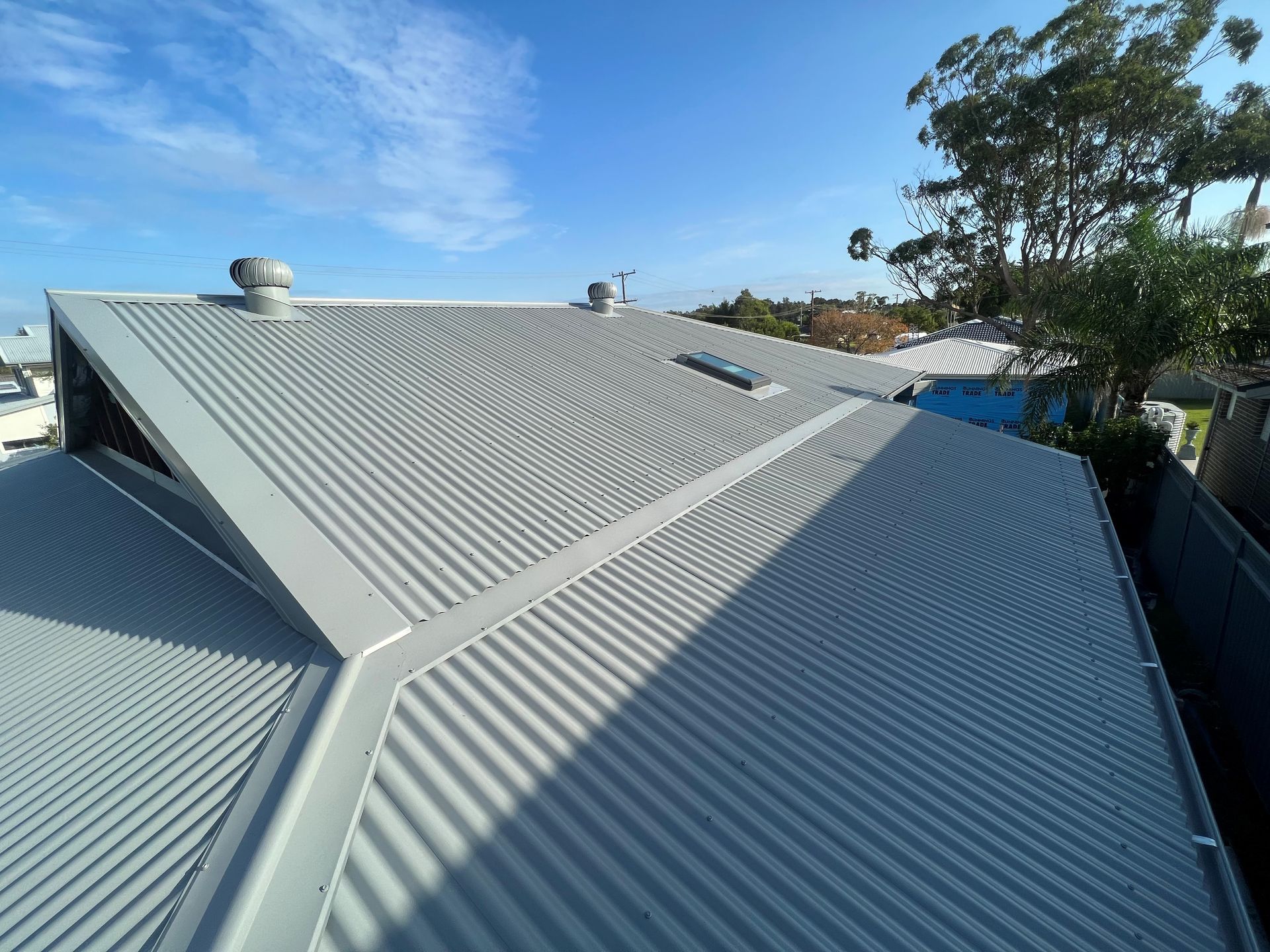 A close up of a roof with a blue sky in the background.