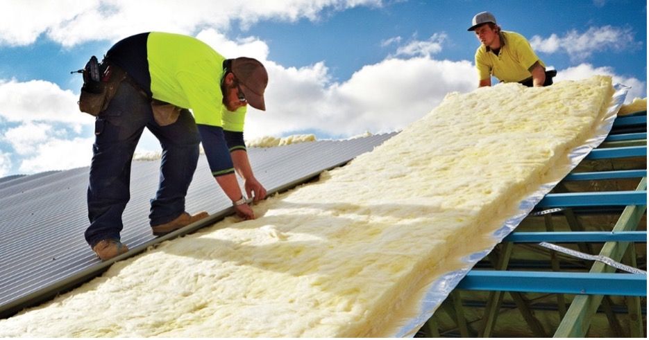 Two Men are Working on the Roof of a Building — Fascia in Gosford, NSW