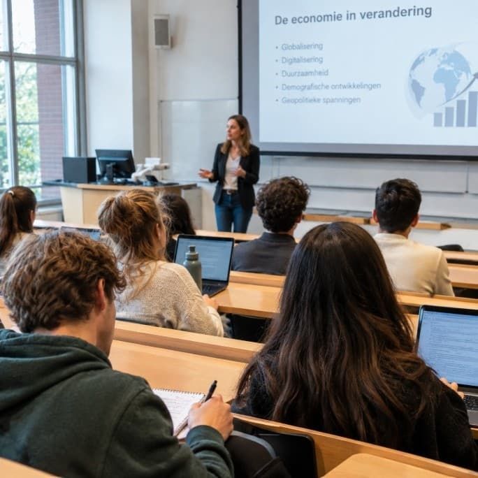 Studenten en docent in collegezaal.