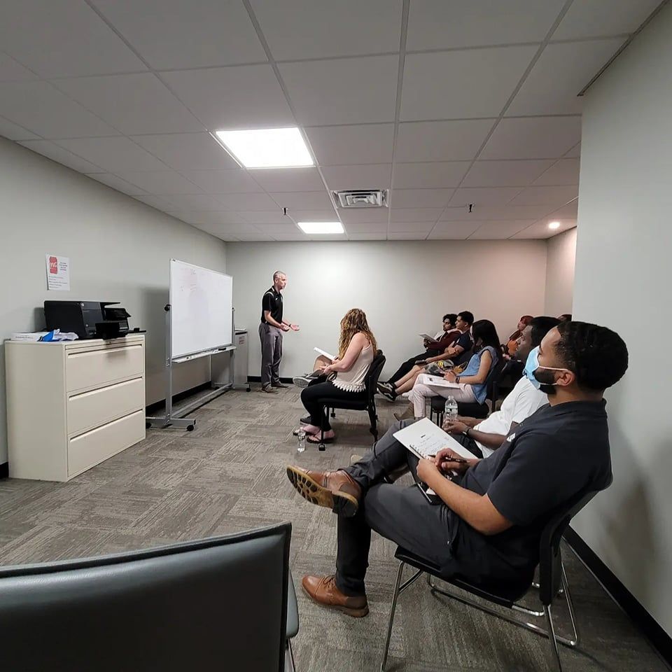 A group of people are sitting in chairs in a room