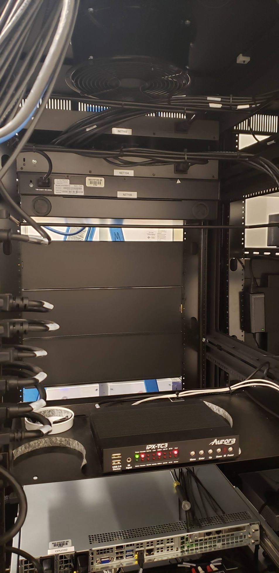 A server rack with a lot of wires coming out of it.