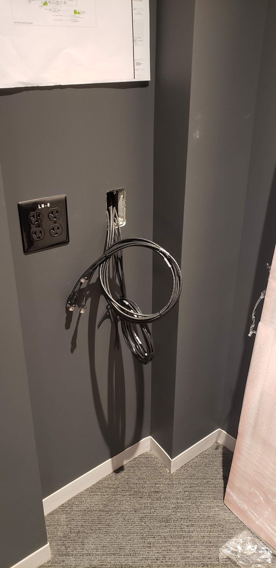 A basketball hoop is hanging from a wall in a room.