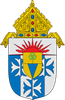 Heraldic shield with blue-and-white quartering, red rays, and a gold bishop&rsquo;s mitre atop