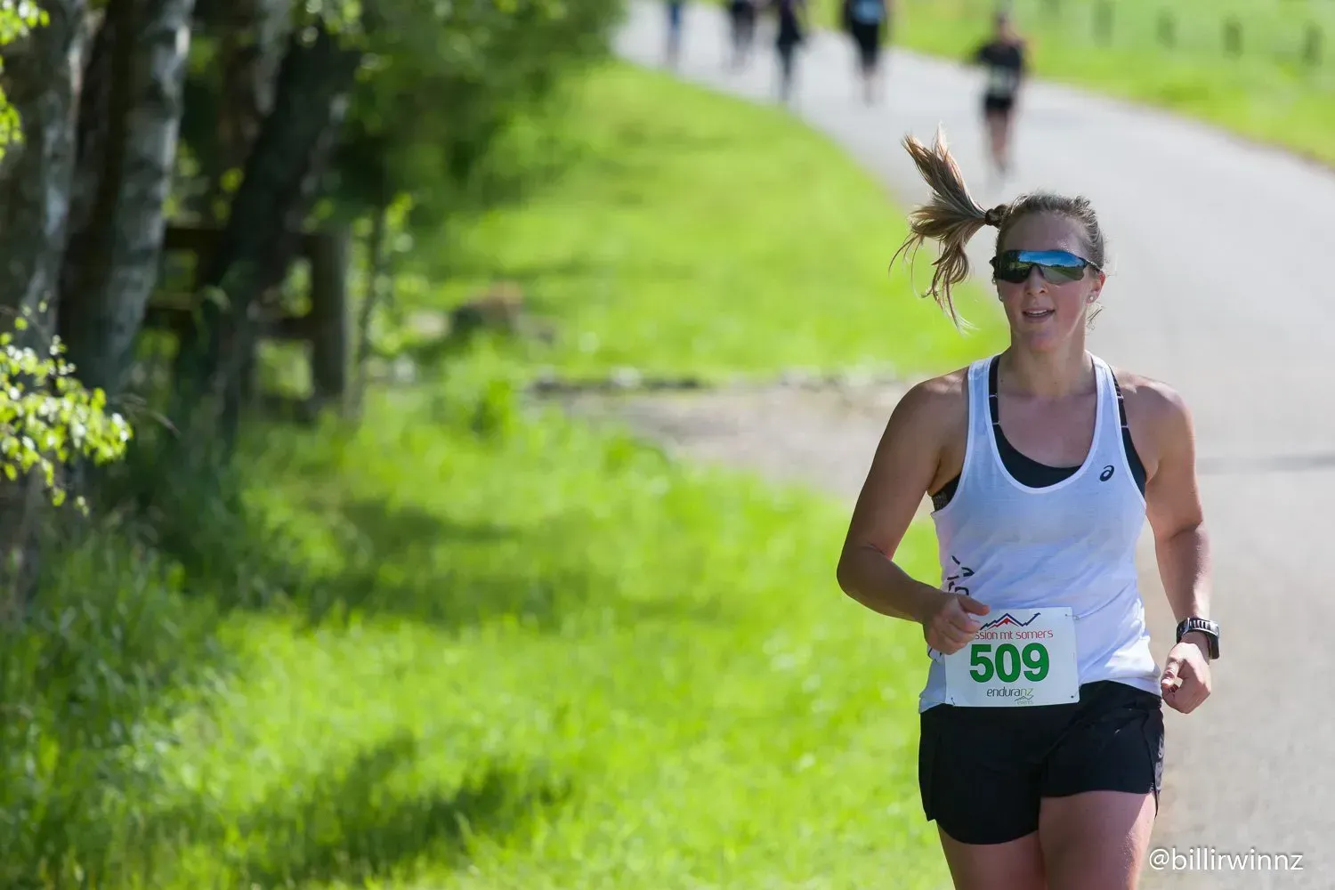 A woman is running a marathon on a path.