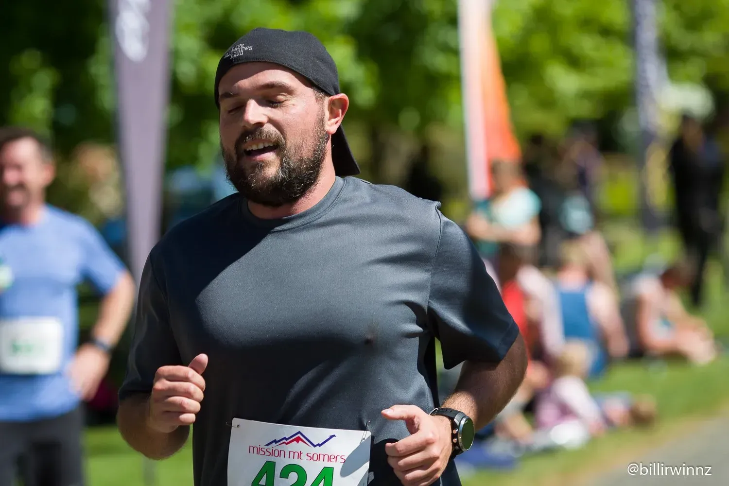 A man with a beard is running in a race.