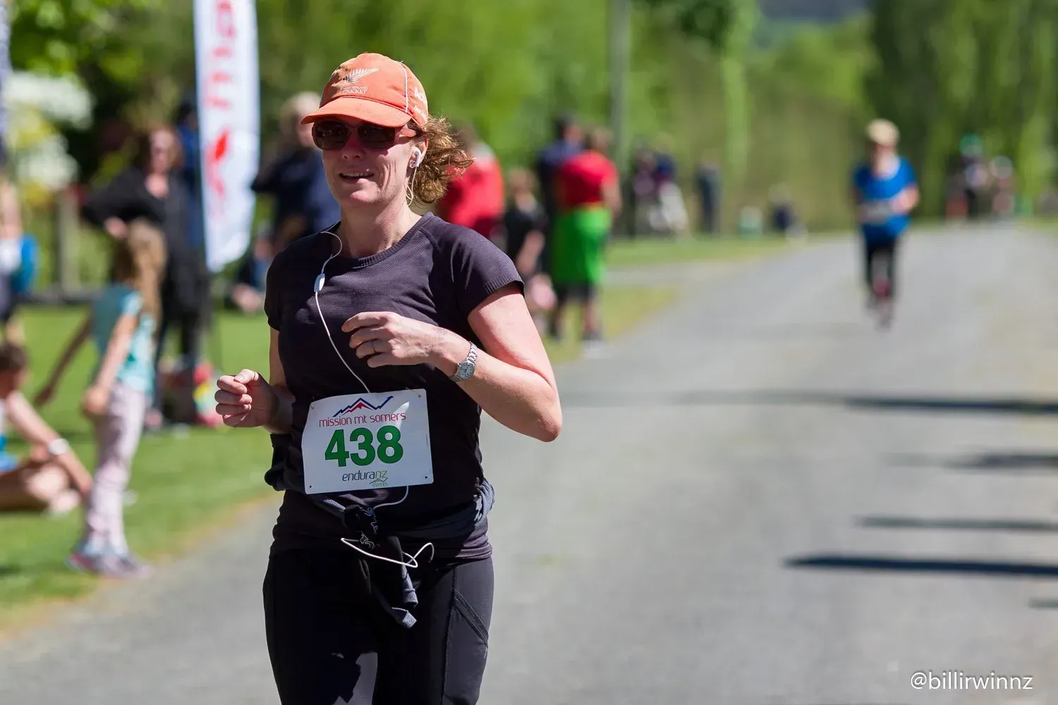 A woman is running in a race with a number on her shirt.