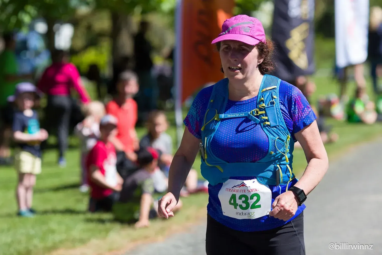 A woman is running in a race with a number on her shirt.