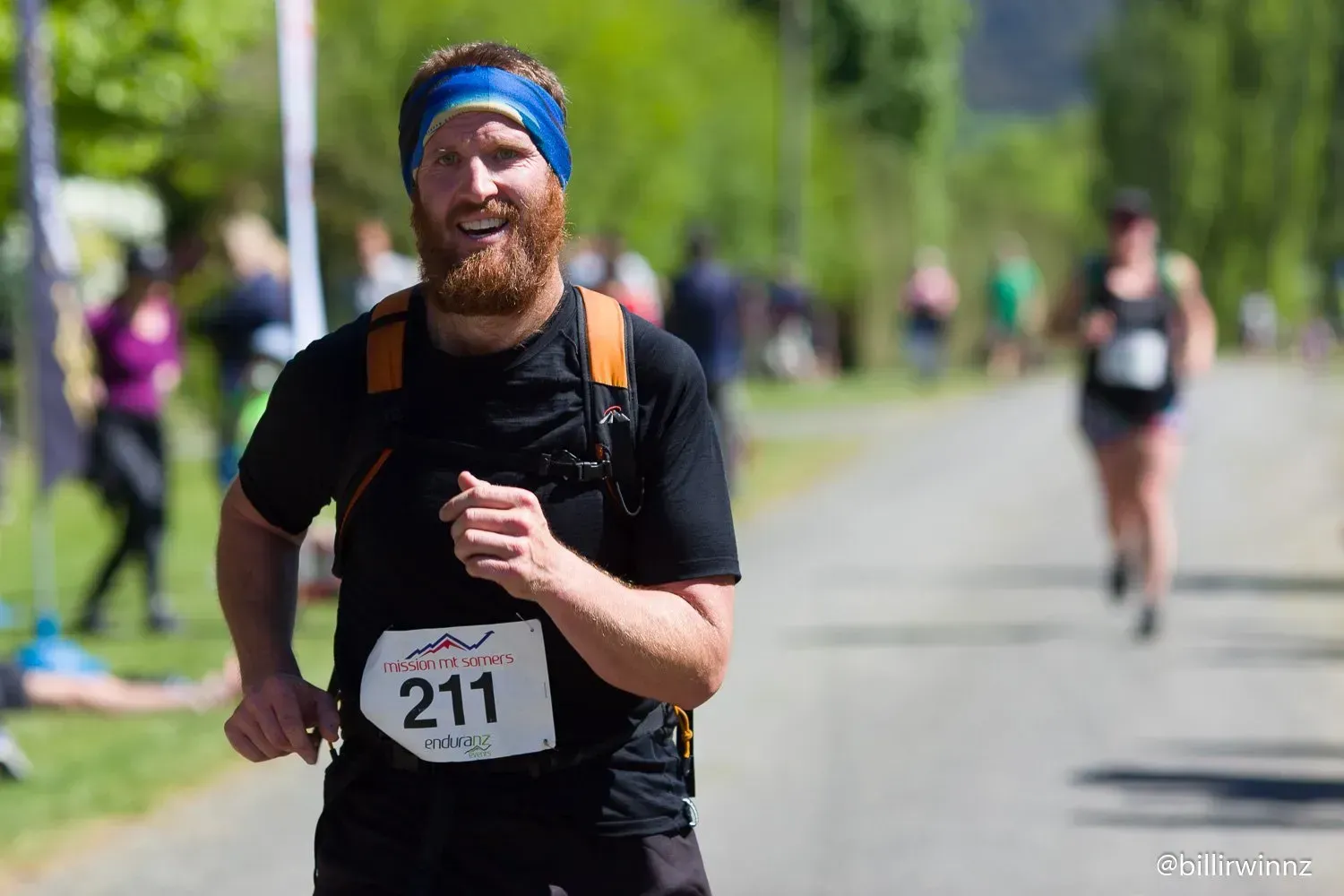 A man with a beard is running in a race.