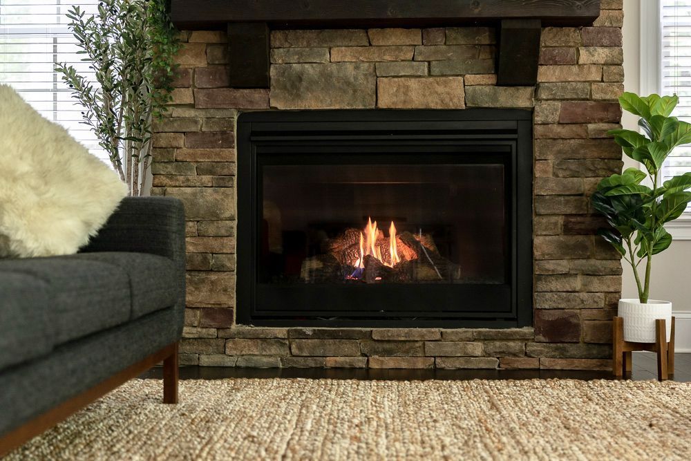 A living room with a fireplace and a couch.