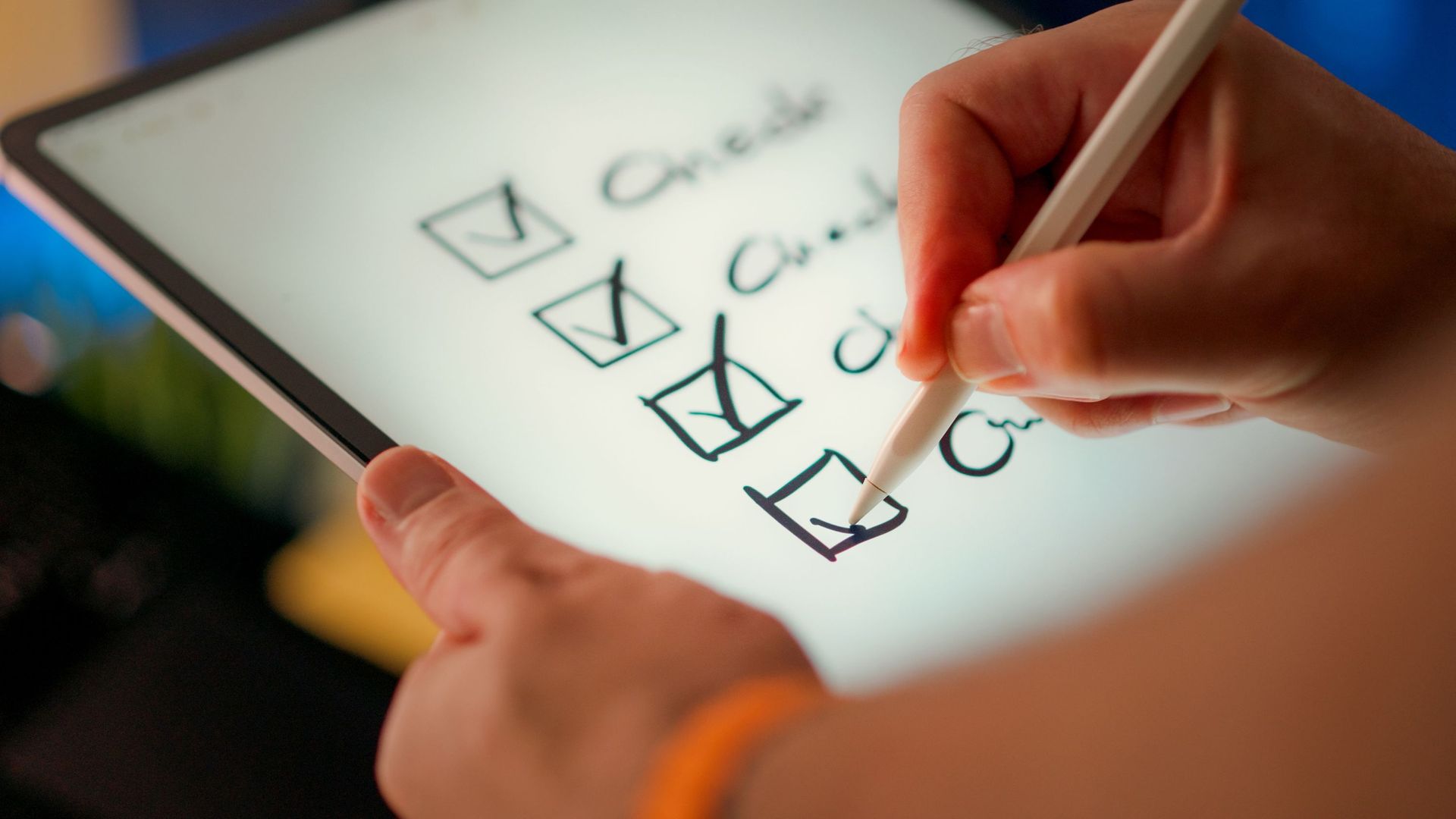 Hand checking boxes on a digital checklist with a stylus on a tablet screen