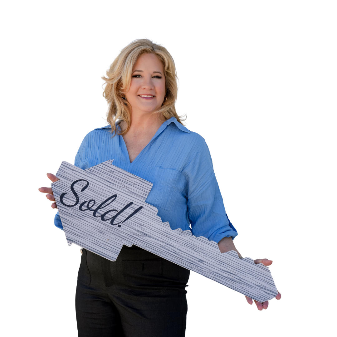 A woman is holding a large key that says soldJana Schautz, Realtor® SRES® Real Estate Agent in The Villages®, FL and Central Florida, Senior Advocate 