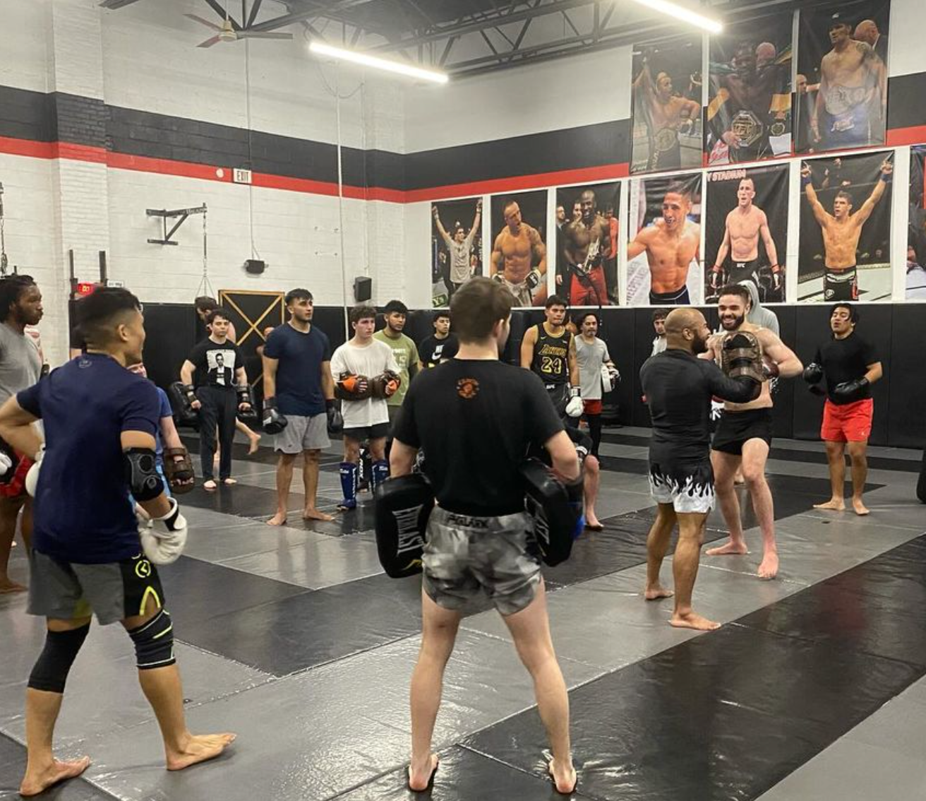 Students train pads and grappling drills at Ray Longo's Mixed Martial Arts in Garden City, NY, building energy and confidence.