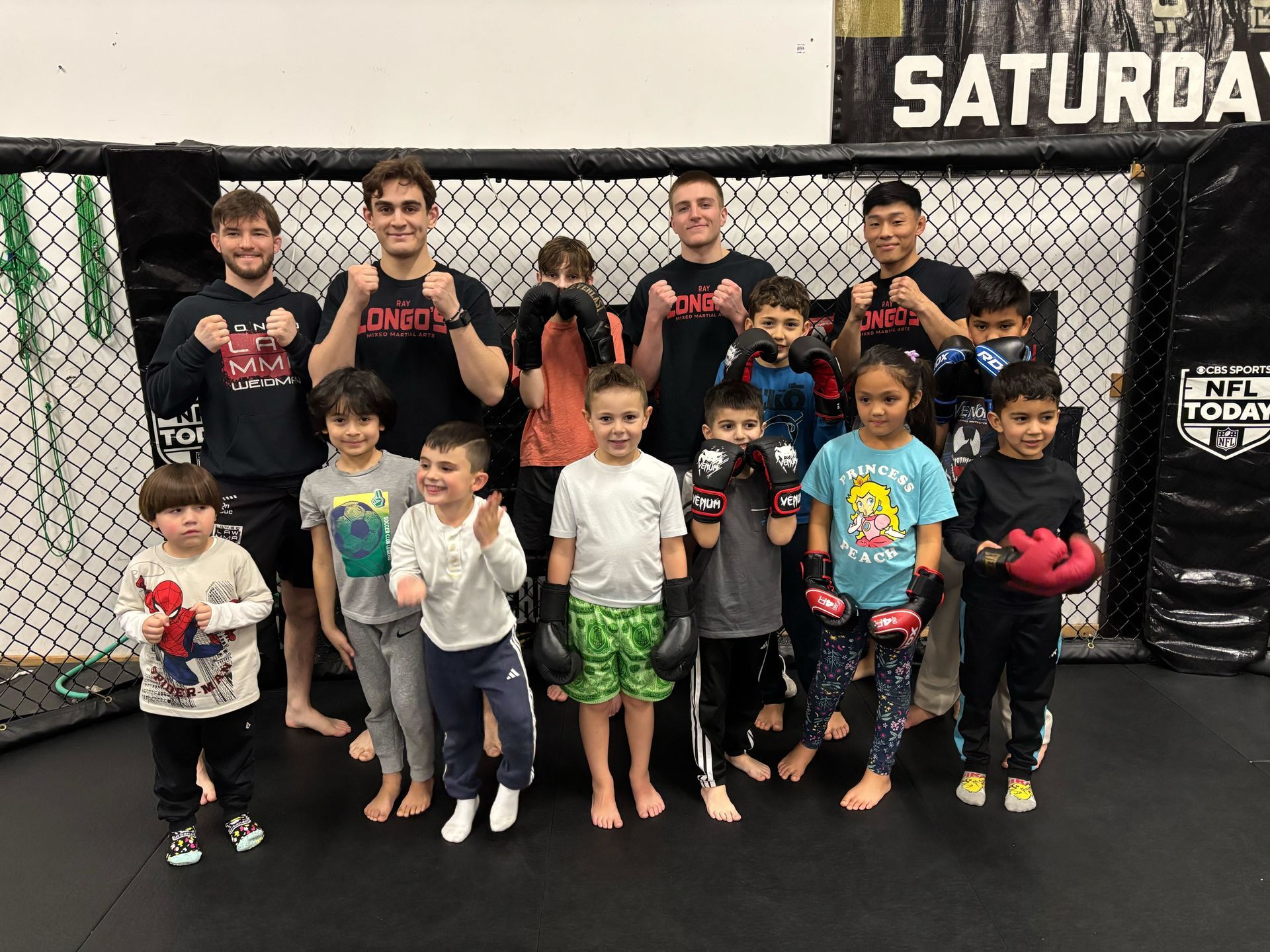 Kids partner-drilling in Youth Brazilian Jiu-Jitsu at Ray Longo's Mixed Martial Arts in Garden City.