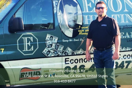 A man stands in front of an economy heating and air van