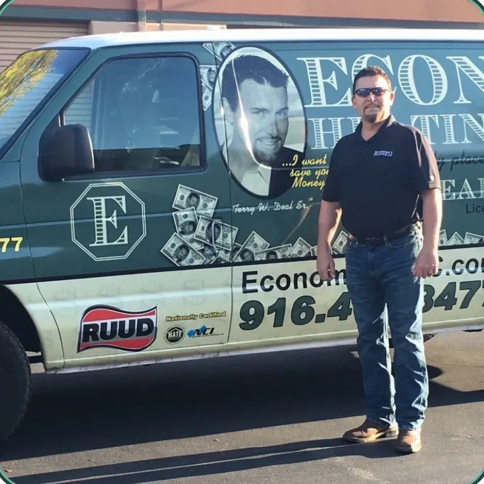 A man stands in front of a green van that says econo