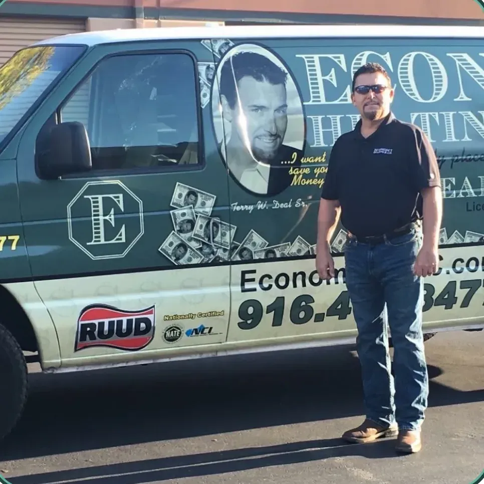 A man is standing in front of a green van that says econo health