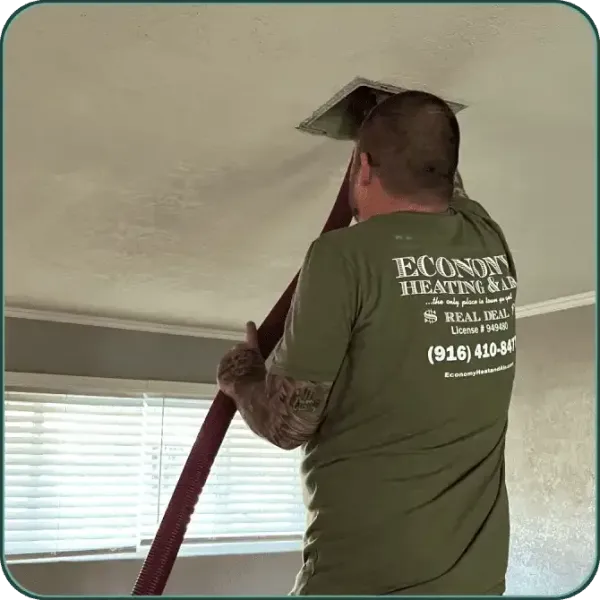 A man wearing a green shirt that says econox heating & cooling
