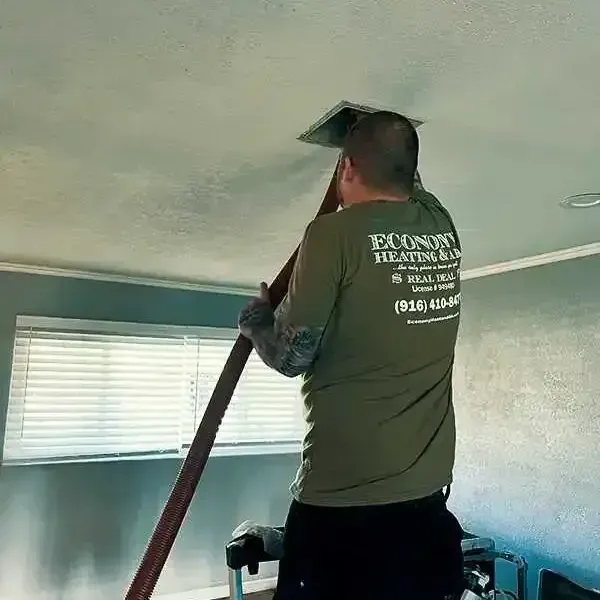 A man is working on a ceiling with a ladder.