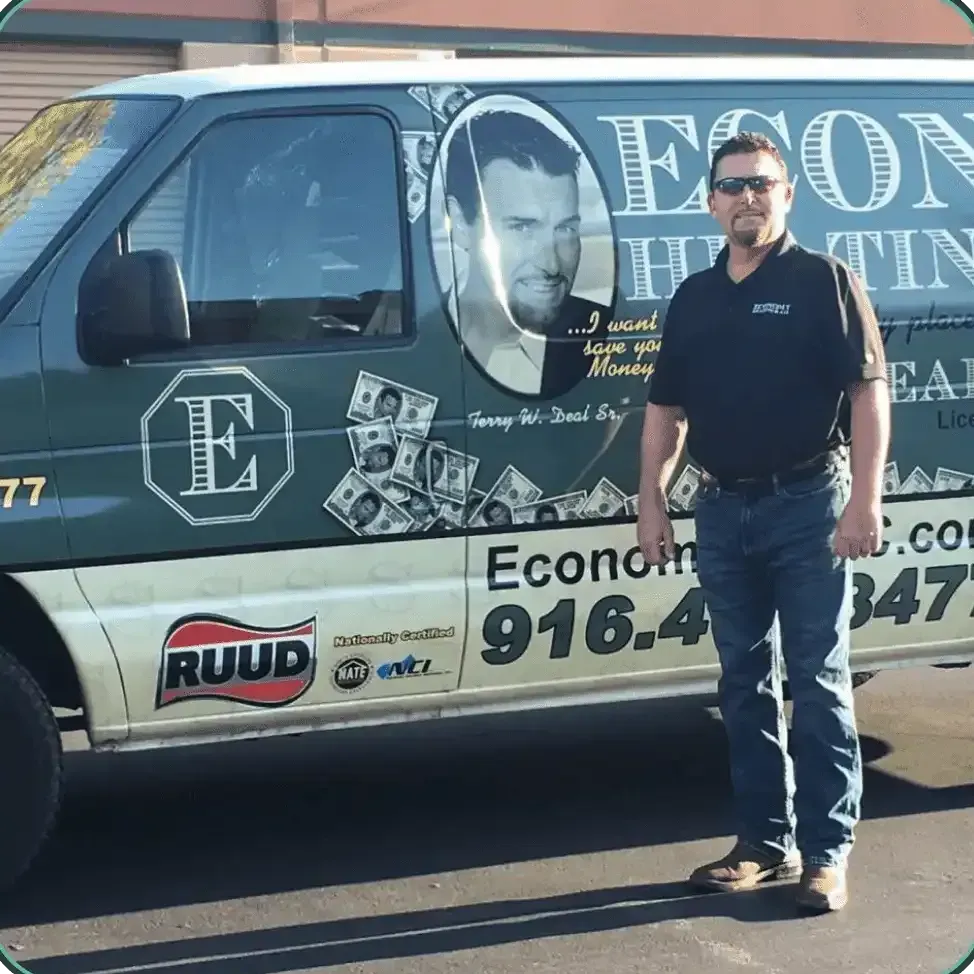 A man stands in front of a van that says econo