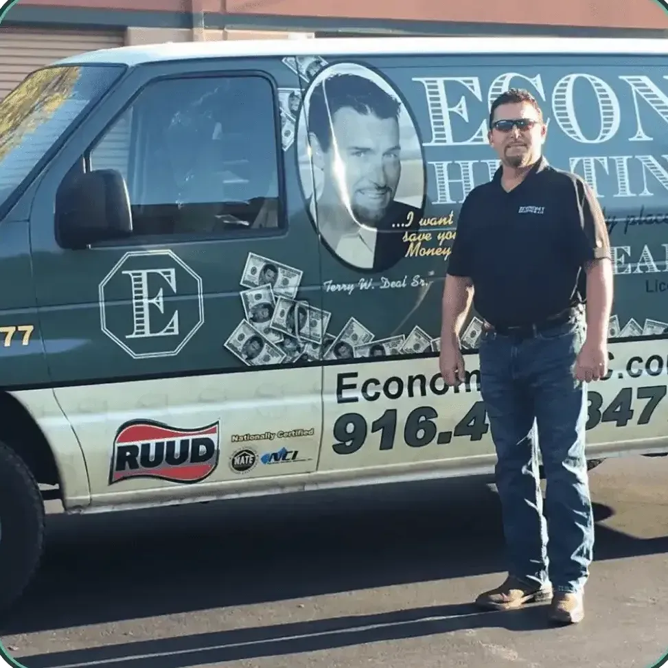 A man standing in front of a van that says econo