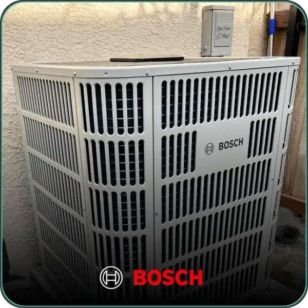 A bosch air conditioner sits outside in front of a wall