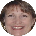 A close up of a woman 's face in a circle smiling.