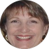 A close up of a woman 's face in a circle smiling.