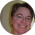 A woman wearing glasses is smiling in a circle.