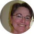 A woman wearing glasses is smiling in a circle.