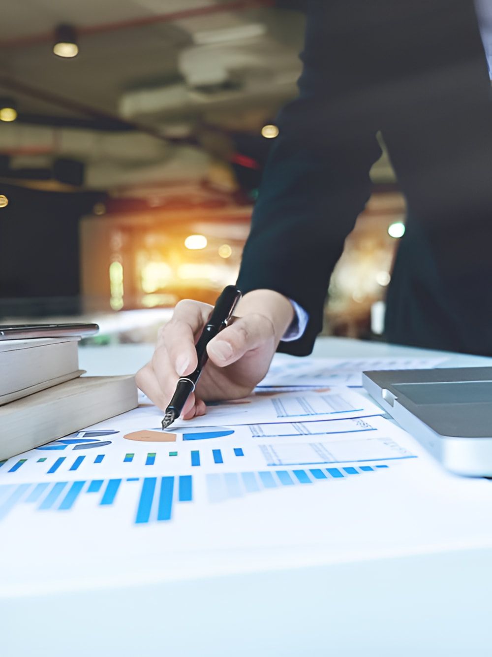 A Person is Writing on a Piece of Paper With a Pen — AJA Bookkeeping Services In Cairns, QLD
