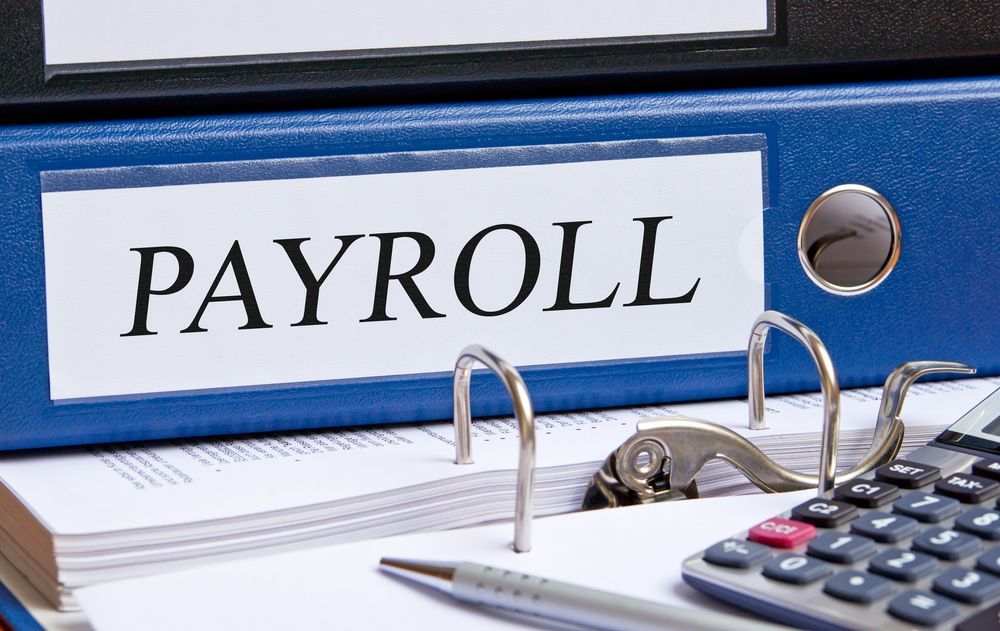 Blue Payroll Binder With Papers, Pen, and Calculator — AJA Bookkeeping Services In Mareeba, QLD