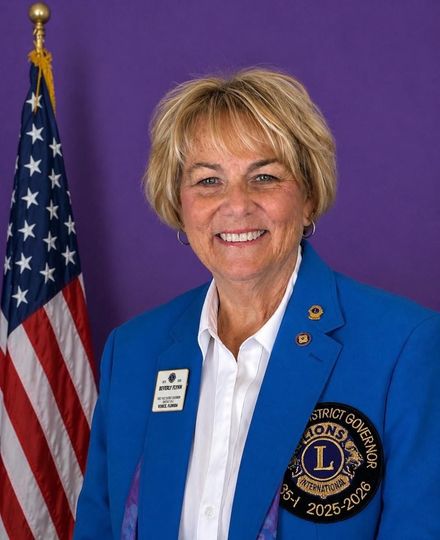 A woman standing in front of an american flag and a puzzle