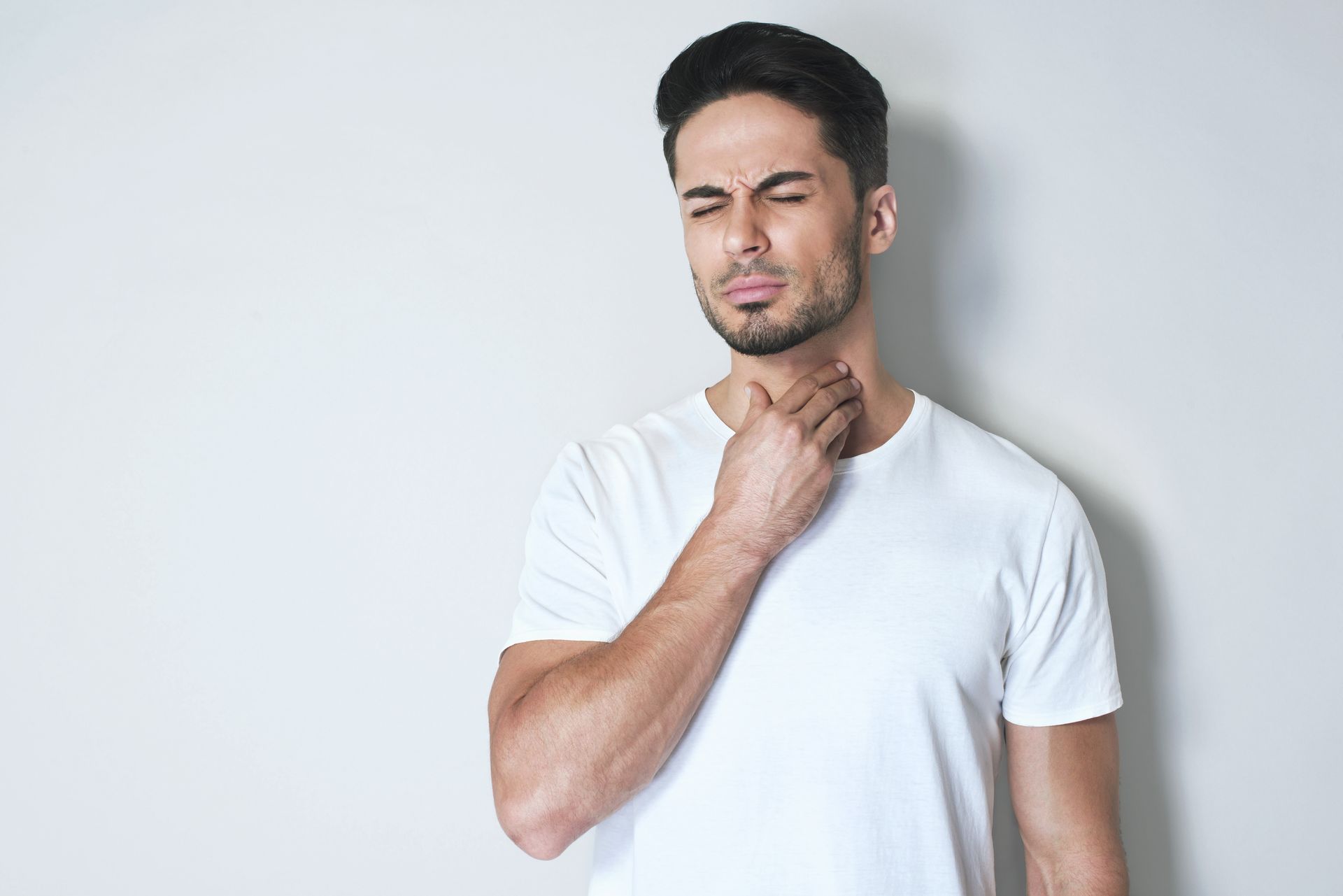 sick man holding throat