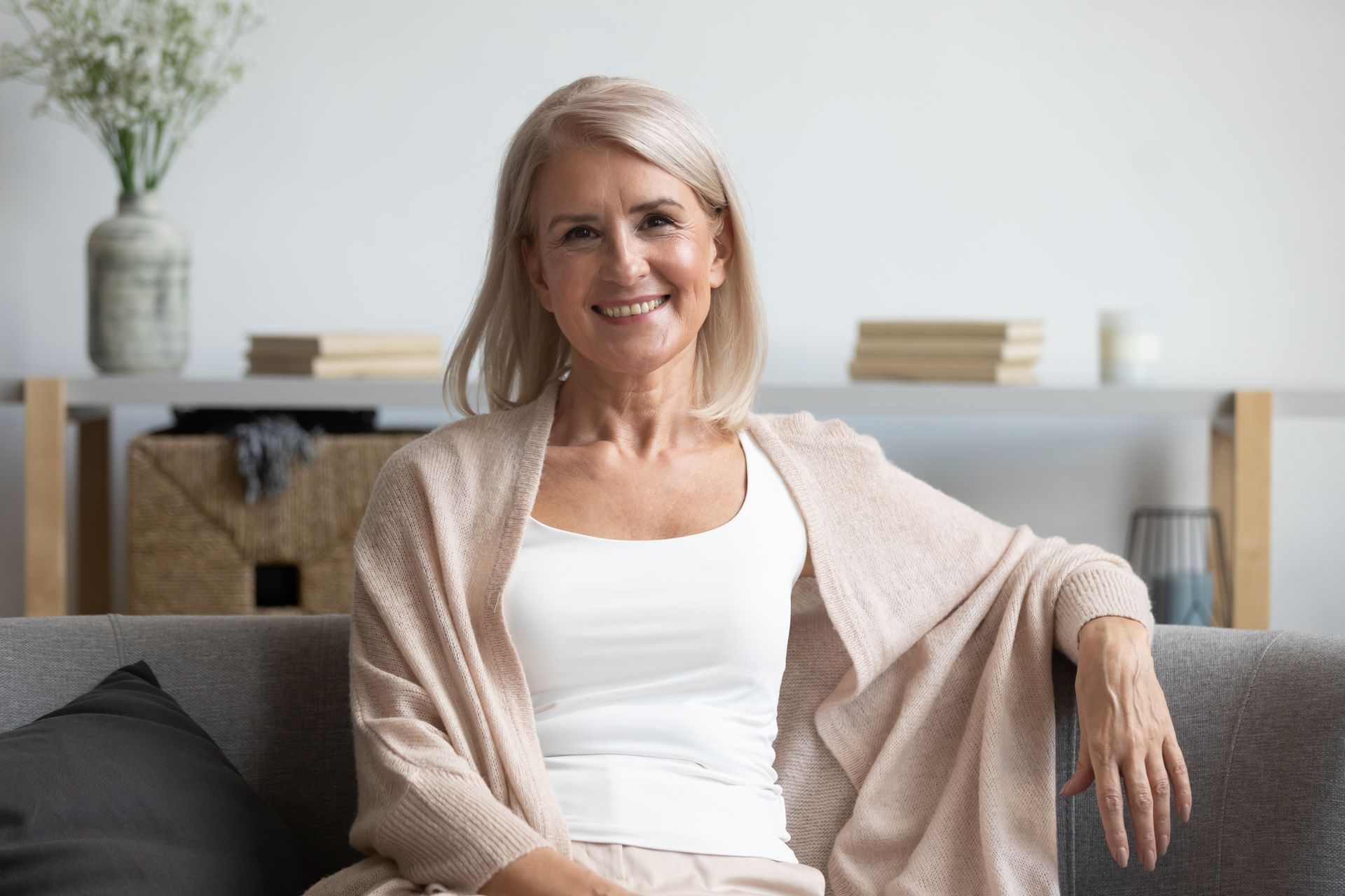 middle aged woman smiling on couch