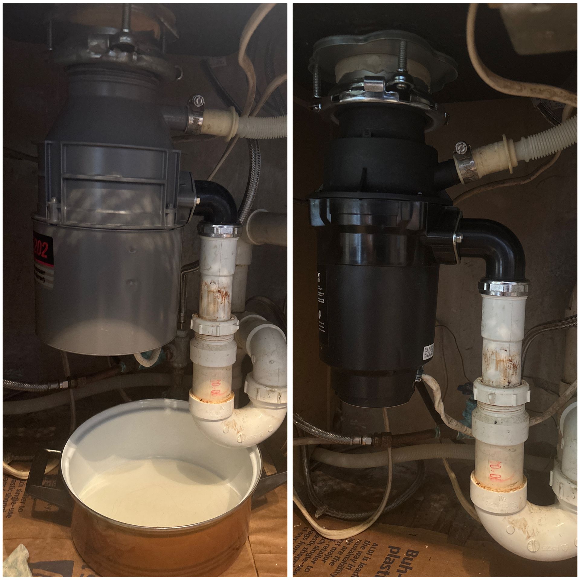 Under-sink plumbing with a black garbage disposal and a bucket catching water from a leak.