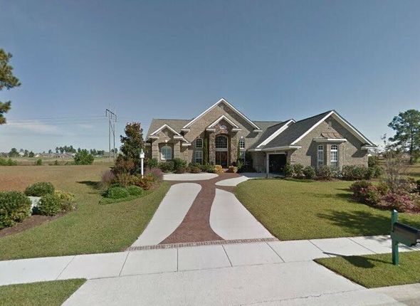A large house with a driveway leading to it