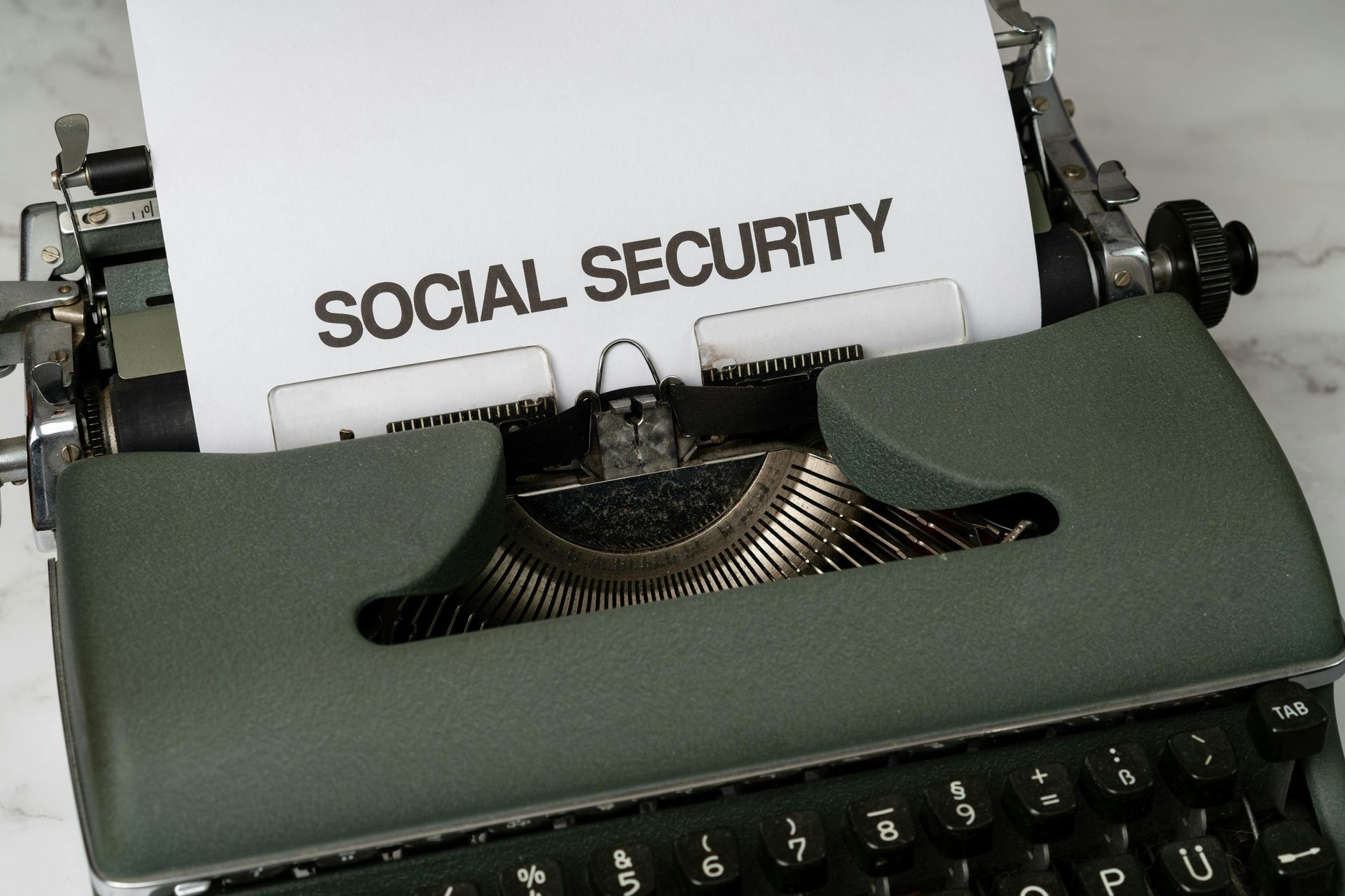 Typewriter with paper labeled “SOCIAL SECURITY” inserted in the carriage.